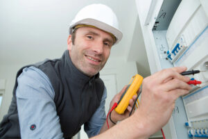 smiling technician testing and providing Residential Electrician in Boca Raton, FL 