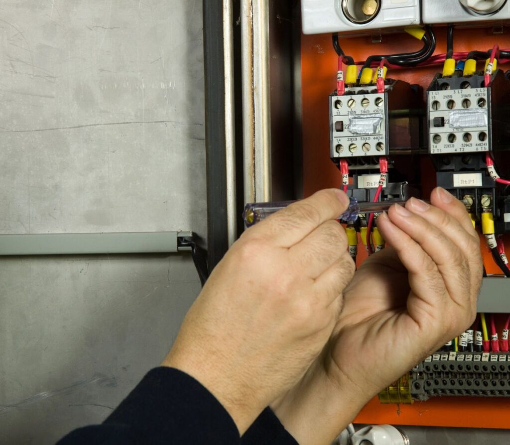 Technician performing an electrical panel replacement in West Palm Beach, FL