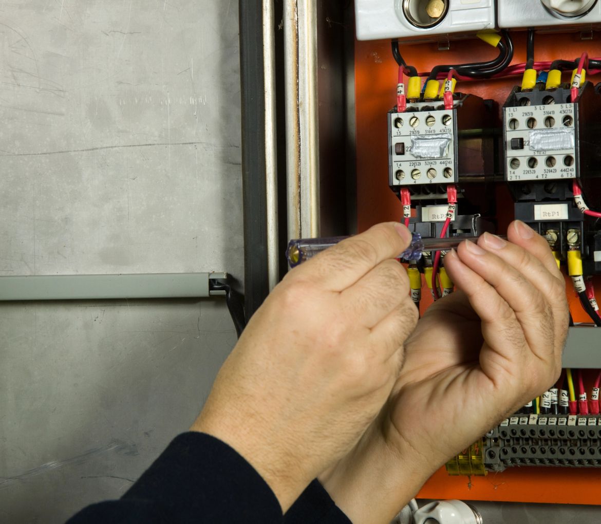 Technician performing an electrical panel replacement in West Palm Beach, FL